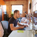 People working at computers in a modern office setting