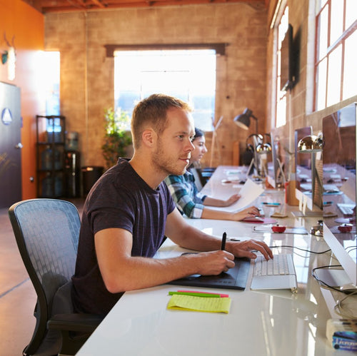 People working at computers in a modern office setting