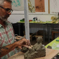Person working on sculptures in a studio setting.