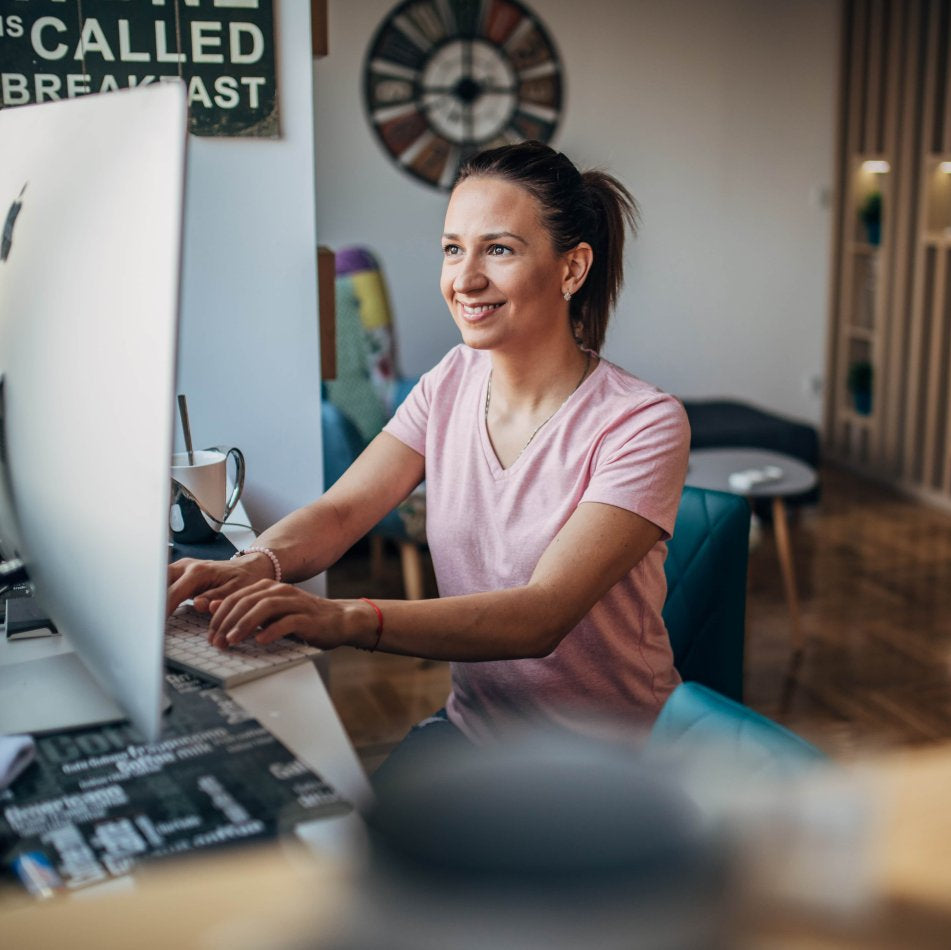 Woman using a computer in a home office setting